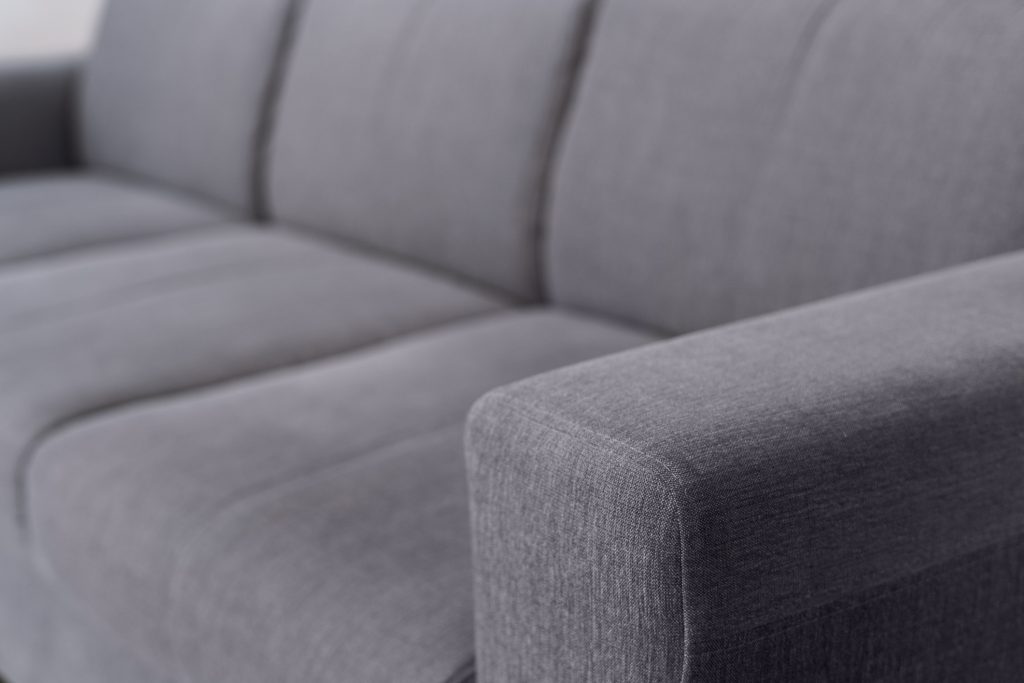 selective focus on upholstery of grey sofa